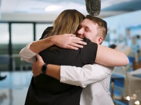 AdventHealth nurse Delaney Postma and UCF student Maxwell Jones hug, after seeing each other for the first time since Jones was accepted into the College of Nursing.