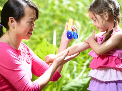 Applying sunscreen to child