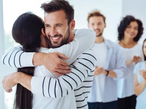 A organ donor hugs someone they helped save with a living donation.