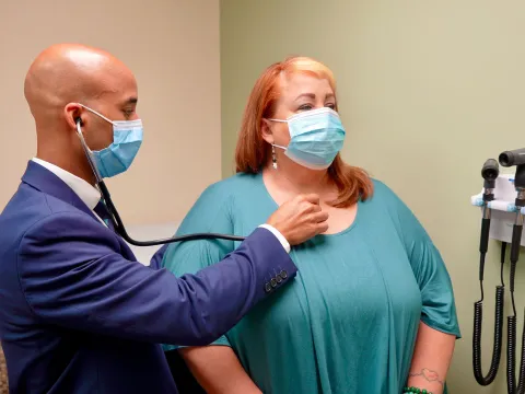 Post-COVID Clinic lead physician, Dwayne Gordon, M.D., sees a long COVID-19 patient at the clinic.