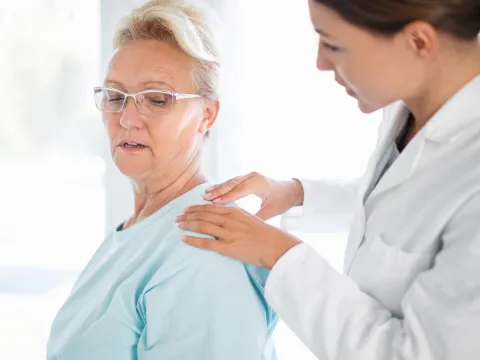 Woman Discussing Her Pain with Doctor