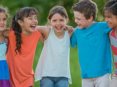 Children playing and linking arms