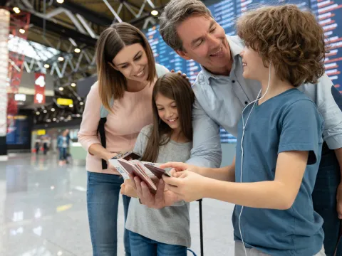 A family double checks their passports before an international flight.