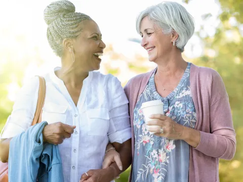 Two women walking and talking about their health.