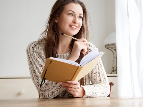 A woman writes in her journal.