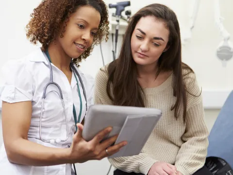 A young woman consults with her physician.