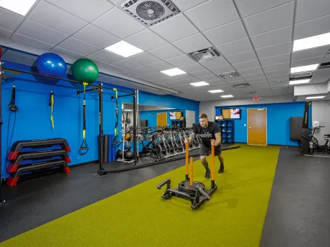 A man working out in the AdventHealth Wellness Center training room