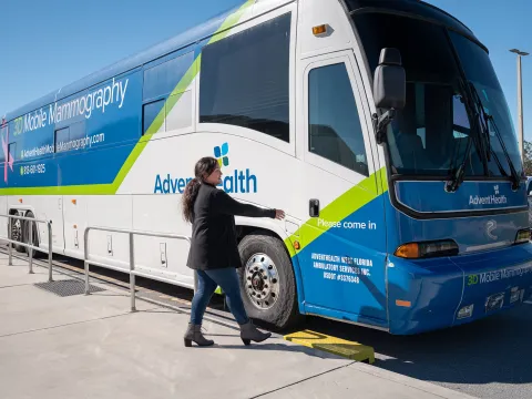 A woman going into an AdventHealth bus that provides mobile mammography