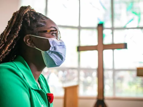 An AdvenHealth employee in a facility chapel room