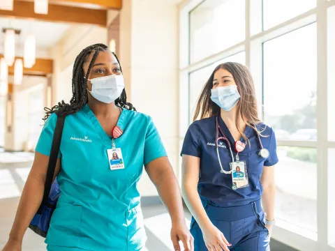 Two AdventHealth nurses walking down the hallway