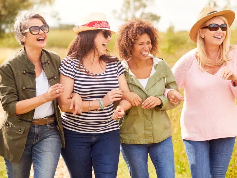 Woman walking and laughing outdoors