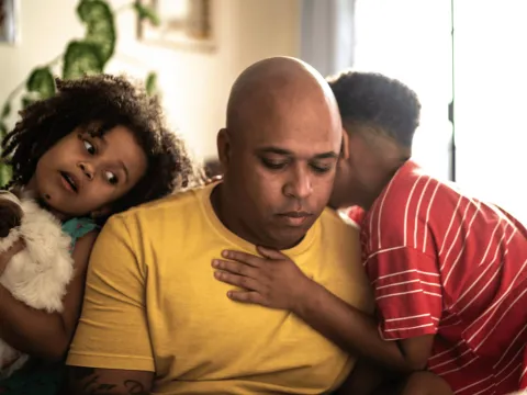 A tired-looking father with his two children.