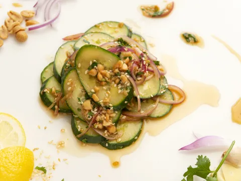 Mound of cucumber salad with lemon garnish