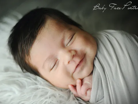 smiling baby sleeping.