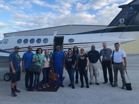 Bahamas recovery efforts team in front of airplane