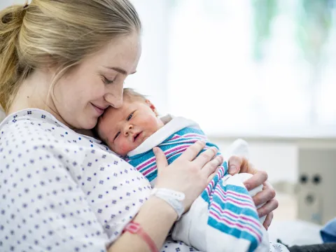 mother holds newborn baby