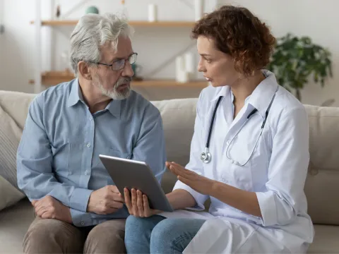 An older man speaks to his doctor