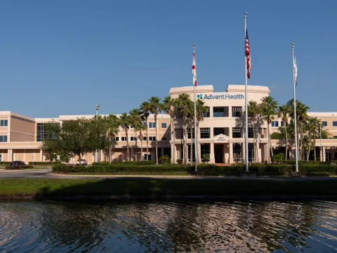 An exterior photo of AdventHealth Palm Coast across a lake.