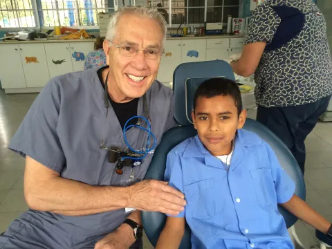 AdventHealth Sharing Smiles, Dentist with patient on mission trip.