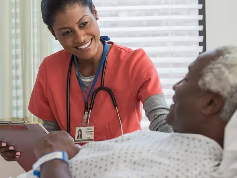 Doctor standing beside a patient's bed