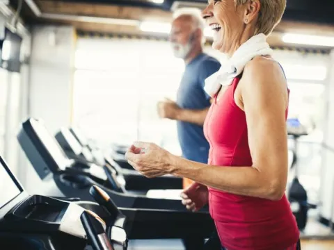 A Senior Couple at the Gym Running on Treadmills