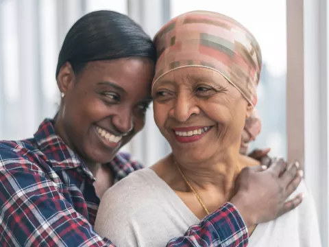 An Adult Daughter Hugs Her Senior Mom