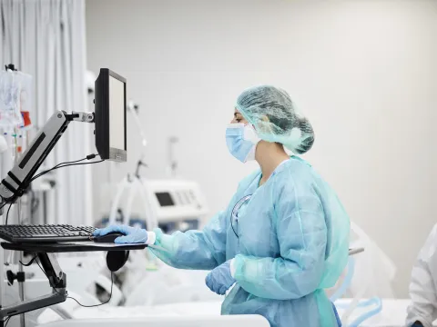 Physician looking at computer