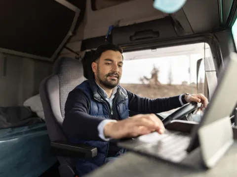 A Commercial Driver Check's the Laptop in His Truck