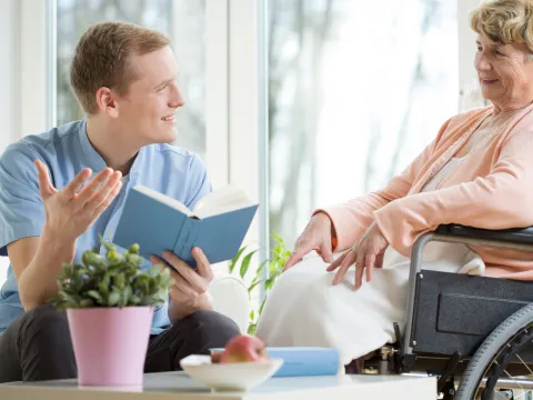 A CPE Pastor Reads the Bible to a Patient