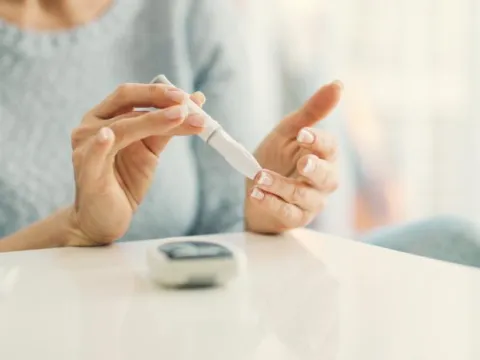 A Close Up of a Senior Person Checking Their Glucose with a Monitor
