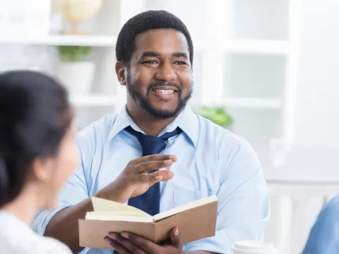 A CPE Pastor Reads the Bible to a Patient