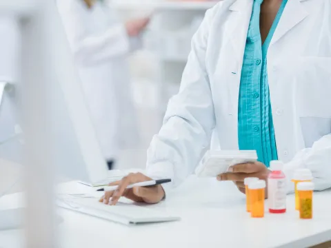 Female pharmacist on a computer.