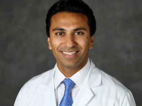 A professional headshot of Dr. Raj Martinez