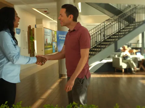 A patient shakes hands with an AdventHealth employee at a Health park facility.