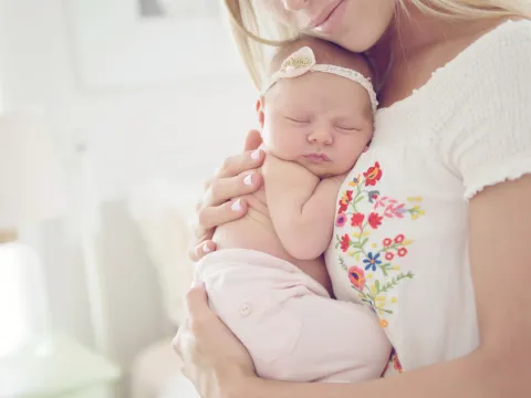 A mother holding her baby.