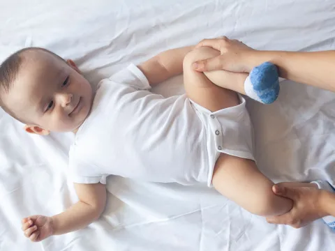 A baby laying on a bed