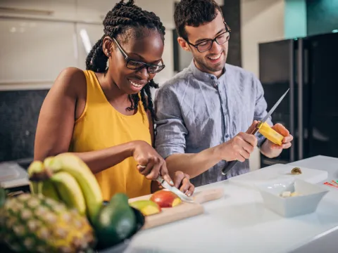 A couple slicing mango.