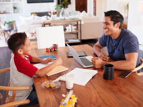 Dad working from home with his son