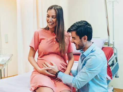 A young woman and man at the doctor for a pregnancy check-up