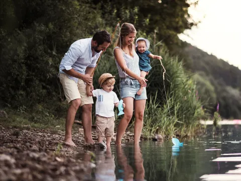 A family standing by the water.