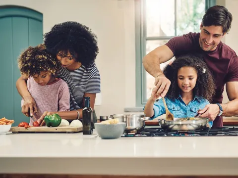 A family cooking a healthy meal together.