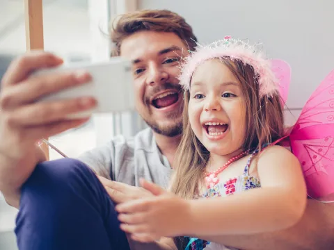 A father and daughter stay connected with a video call.