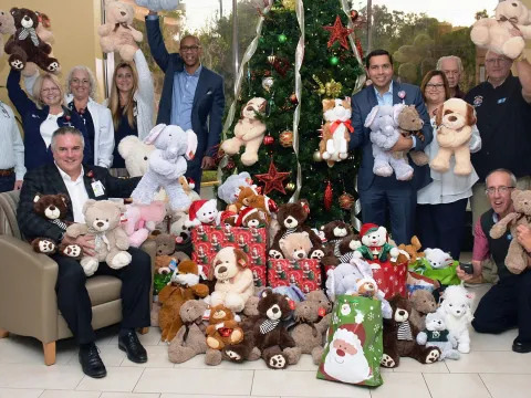 AdventHealth employees and doctors holding up teddy bear donations