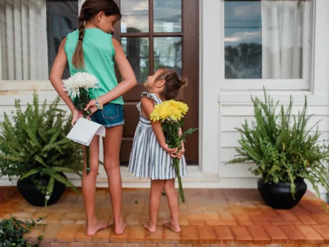 Two girls holding gifts