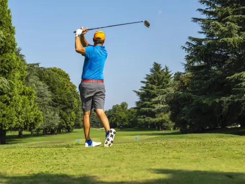 A golfer teeing off.