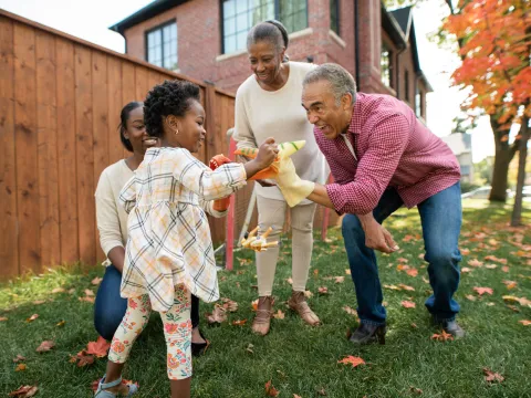 Grandparents engaging with their granddaughter, happily