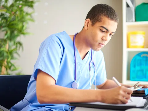 Male Doctor writing