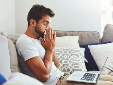 A man blows his nose