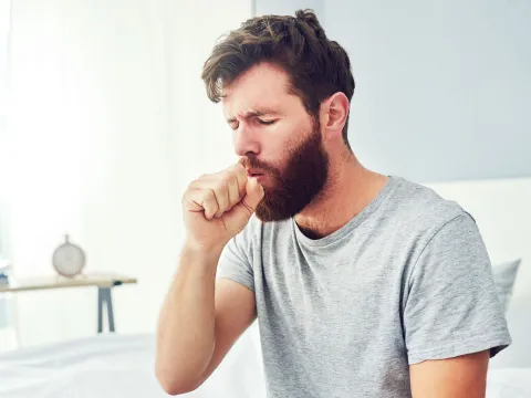 A man coughing.