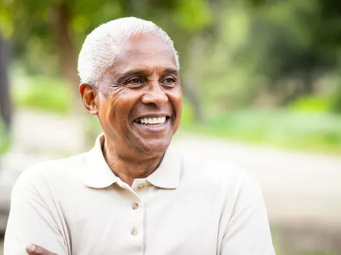 A man smiling outside. 